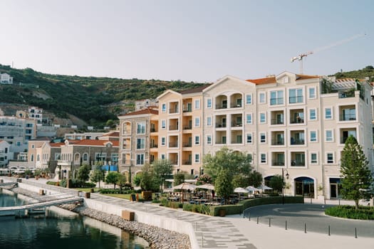 Colorful apartment buildings on the sea promenade at the foot of the mountains. High quality photo