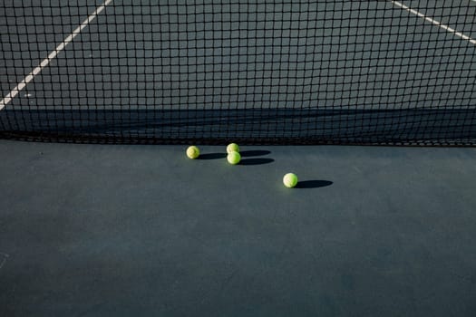 Yellow tennis balls on court and black net. The concept of outdoor game sports. Flat lay