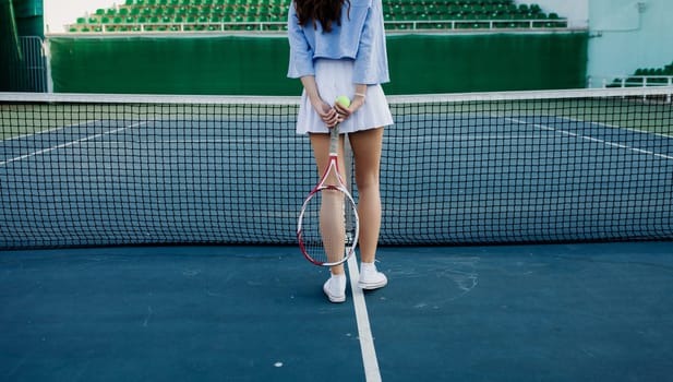 Tennis player. Female athlete with racket on tennis court. Fashion and sport concept.