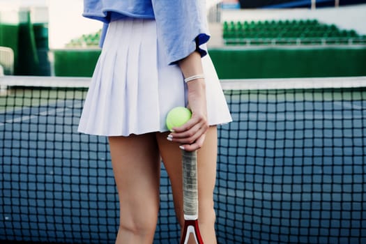 woman holds a tennis racket in her hands. rear view. sports concept