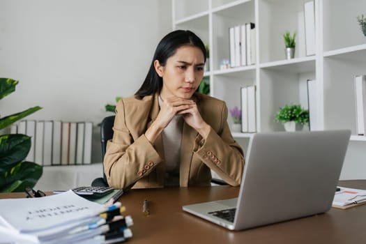 Young woman overworked exhausted of use a laptop, Burnout frustrated with anxiety problems sitting at home office.