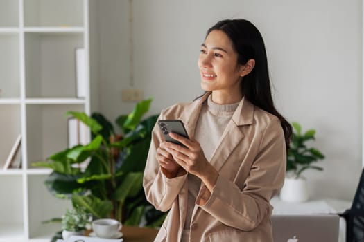 Business woman relax with mobile and look out window during work.