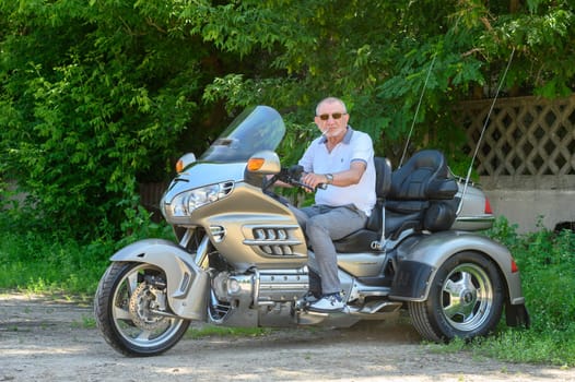 elderly man sitting on a motorcycle 1