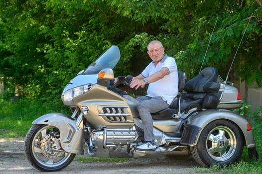 elderly man sitting on a motorcycle