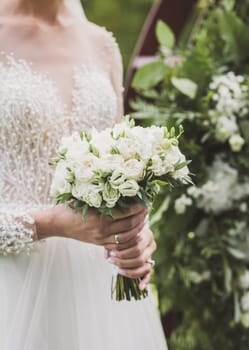 Bride holding wedding bouquet on wedding ceremony