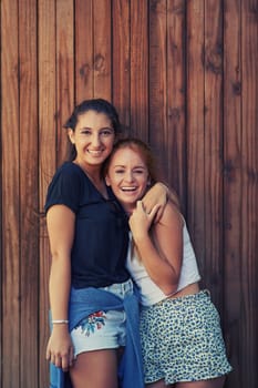 Portrait, smile and woman friends on wooden background together for bonding or relationship. Love, funny or laughing and happy young people having fun with fashion in summer for holiday and vacation.