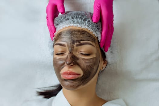 Close-up of carbon peeling procedure for middle-aged woman face. Laser pulses clean skin. Process of photothermolysis, warming, laser carbon peeling. Facial skin rejuvenation, cosmetology treatment