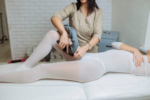 Beautiful woman getting beauty therapy against cellulite with LPG machine on her butt. LPG massage for lifting body