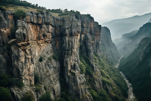 Top view of beautiful rocks with greenery in the fog.