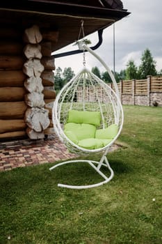 Beautiful garden with comfortable hanging chair