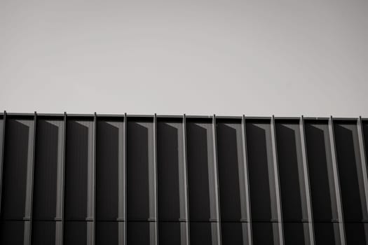 Business building. Abstract architecture, fragment of minimalistic urban geometry. Walls made of steel 