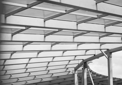 Metal grid structure. Abstract black and white background image on the subject of modern architecture, industry or technology.