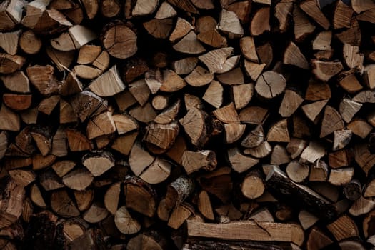 Firewood storage close up. Stocks of wooden logs close-up. Chopping wood. Rustic lifestyle. Wooden texture.