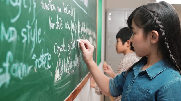 Skilled asian girl writing engineering prompt and programing system while standing blackboard with generated AI prompt written by diverse smart student at STEM technology lesson. Education. Pedagogy.