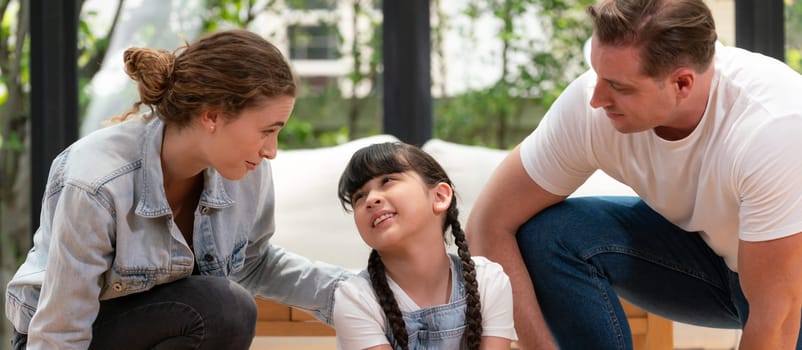 Parents comforting their daughter with loving embrace, helping her feel secure and protected as she rest her head on their shoulder. Happy family love and child care support Panorama. Synchronos