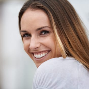 Portrait, woman and smile in city for leisure, calm and healthy in outdoor on weekend break. California, face and lady in nature on summer holiday, closeup and happy for relax travel in urban town.