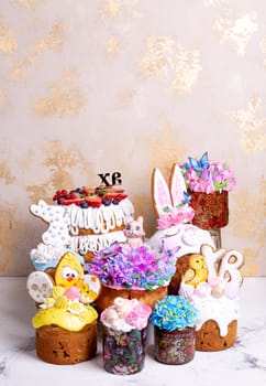 A variety of Easter cakes with intricate icing decorations, featuring bunnies, chicks, flowers, and butterflies. Perfect for a festive Easter celebration. Isolated on a beige background.