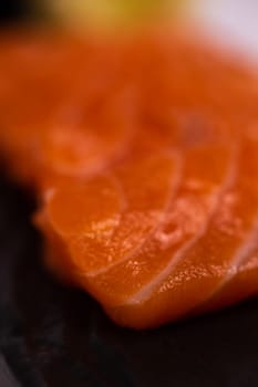 Close-up of fresh raw salmon fillet. Isolated on white background. Salmon is a type of fish that is often used in sushi and sashimi. It has a delicate flavor and a slightly pink color.