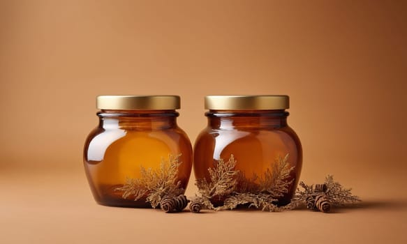 Two glass jars of honey with a blank label on a brown background.