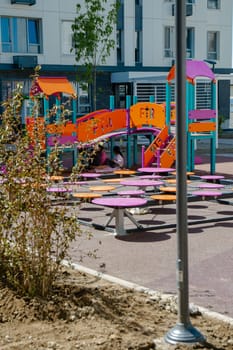 A vibrant playground with colorful equipment for kids, creating a fun and safe environment for families to enjoy together.