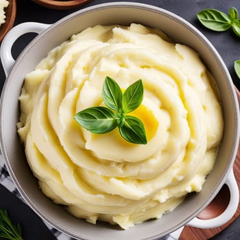 Mashed potatoes in plate on a black background. Restaurant or cafe menu concept.