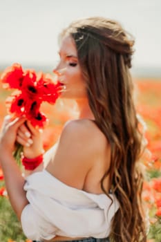 Woman poppies field. Side view of a happy woman with long hair in a poppy field and enjoying the beauty of nature in a warm summer day