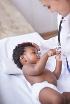 Baby, pediatrician and healthcare consultation with stethoscope as childhood development, examination or ill. Patient, kid and doctor support on hospital bed in Kenya for diagnosis, flu or wellness.
