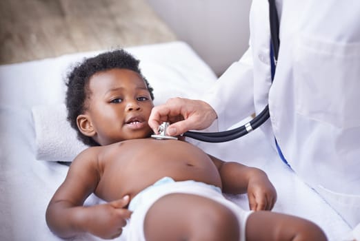 Baby, portrait and pediatrician with stethoscope for heartbeat consultation or lung infection, listening or checkup. Child, boy and face on hospital bed or healthcare wellness in Kenya, clinic or ill.