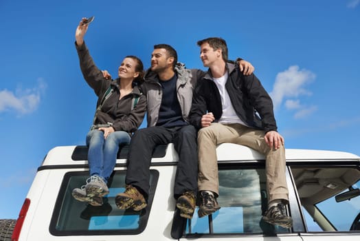 Friends, car and selfie in smile with smartphone for adventure, holiday and road trip to travel in Australia. People, happy and excited for vacation or break with bonding for memory and together