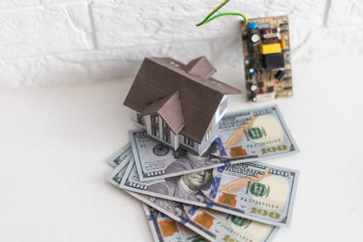 House standing on a pile of dollar bills. Investment, real estate and property concept. High quality photo