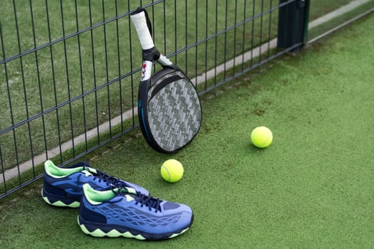Padel tennis racket sport court and balls. Download a high quality photo with paddle for the design of a sports app or soical media advertisement. High quality photo