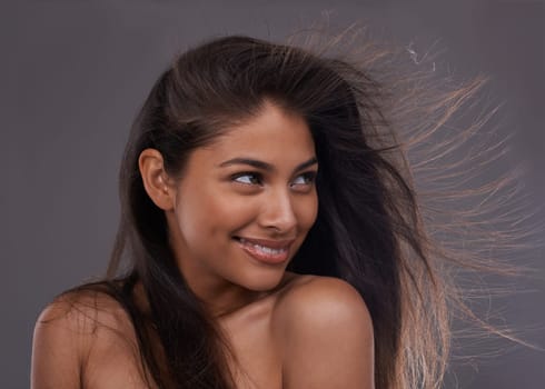 Woman, hair or thinking of haircare, beauty or idea of health, growth and salon aesthetic in studio. Happy, girl or planning of volume, texture or shine as hairstyle vision on grey background.