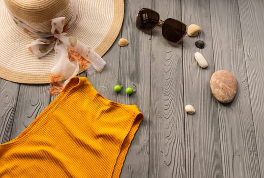 beachwear orange woman top outfit hat bag sun protection sunglasses pebbles. Summer background template mockup free space composition sample text. Top view above wooden background vacation concept