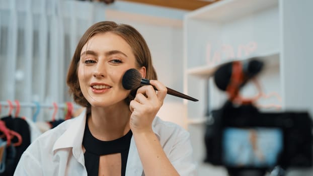 Woman influencer shoot live streaming vlog video review makeup prim social media or blog. Happy young girl with cosmetics studio lighting for marketing recording session broadcasting online.