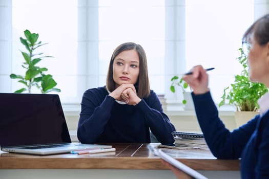 Sad unhappy young woman patient at session with female psychologist therapist social worker counselor psychotherapist. Mental health professional support treatment, feelings stress depression trauma