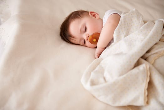 Baby, sleeping and tired from nap with relax child and nursery with peace in a bed with blanket. Morning, toddler and kid with dream of infant with youth development from rest in bedroom with newborn.