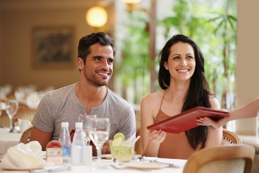 Couple, restaurant and menu with dinner, romance and love for anniversary or celebration. Woman, man and date with luxury, fine dining and smile for relationship on holiday or vacation with meal.