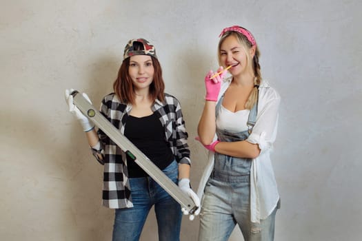 Wipes two sexy girls with a construction tool in their hands. Repair with their own hands inside the house.