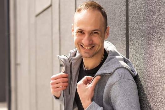 Successful caucasian middle-aged man in casual outfit with arms crossed isolated over gray background.