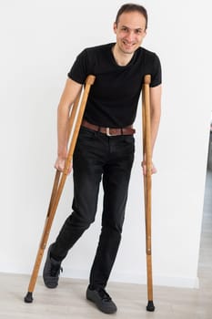 Young man with axillary crutches.