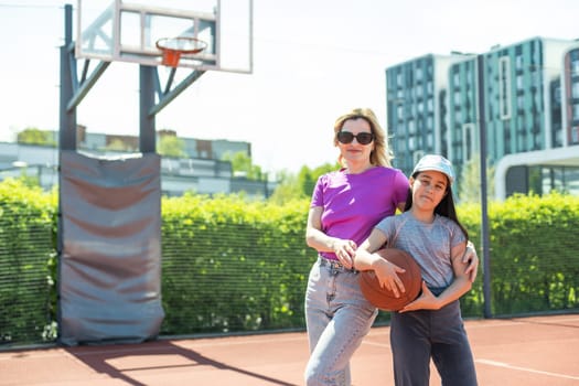 Mother and little daughter after basketball. Great job honey