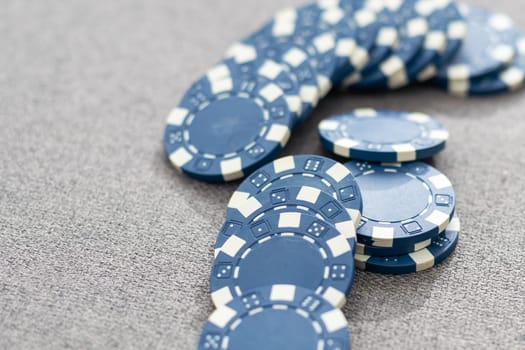 Blue poker chips on stock market chart background. High quality photo