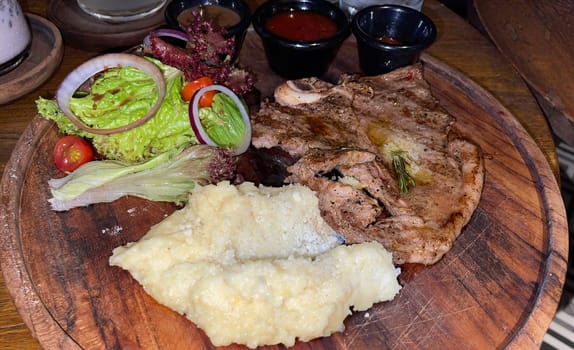 prime sirloin beef steak along with mash potatoes with delicious mushroom sauce and green salad onion new york sirloin