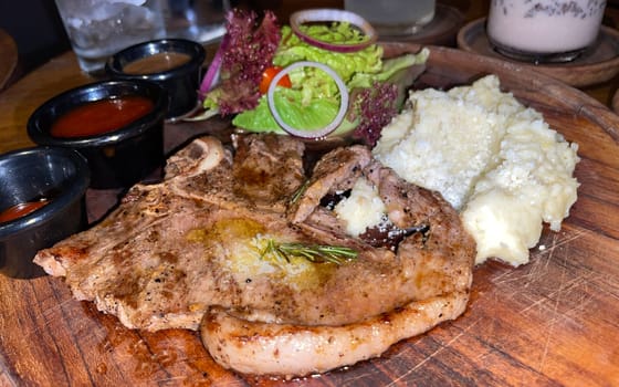 prime sirloin beef steak along with mash potatoes with delicious mushroom sauce and green salad onion new york sirloin