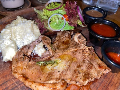 prime sirloin beef steak along with mash potatoes with delicious mushroom sauce and green salad onion new york sirloin