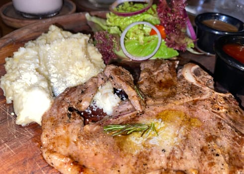 prime sirloin beef steak along with mash potatoes with delicious mushroom sauce and green salad onion new york sirloin