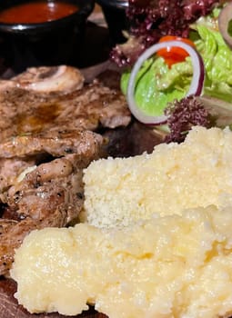 prime sirloin beef steak along with mash potatoes with delicious mushroom sauce and green salad onion new york sirloin