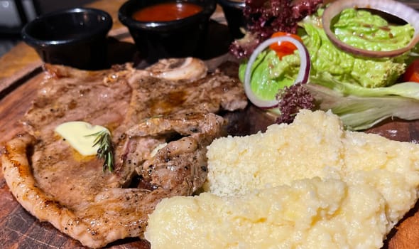 prime sirloin beef steak along with mash potatoes with delicious mushroom sauce and green salad onion new york sirloin