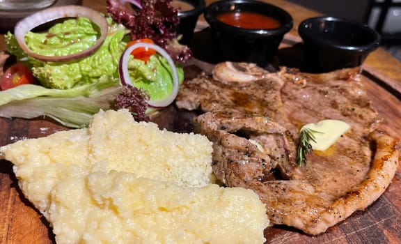 prime sirloin beef steak along with mash potatoes with delicious mushroom sauce and green salad onion new york sirloin
