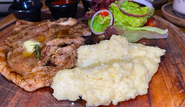 prime sirloin beef steak along with mash potatoes with delicious mushroom sauce and green salad onion new york sirloin